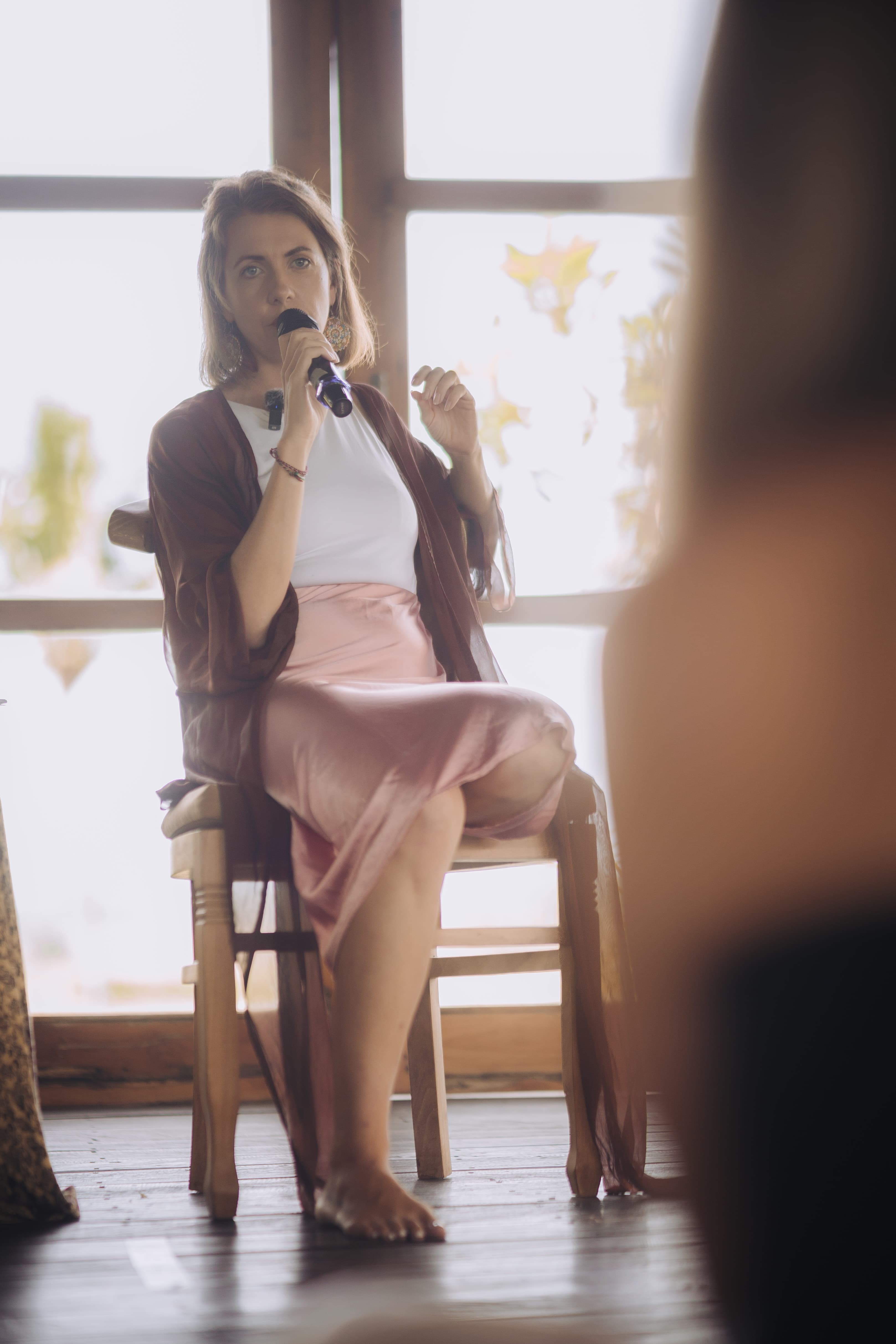 Kirsty seated, speaking to a retreat audience
